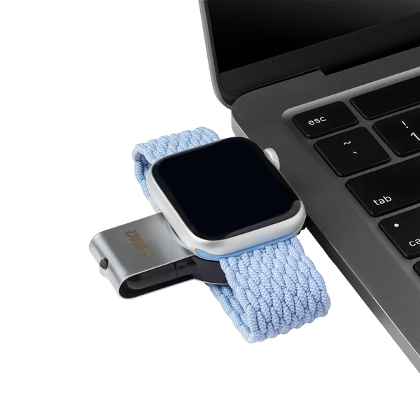 2 in 1 micro Apple watch charger compatible with usb and usb-c sitting on a laptop
